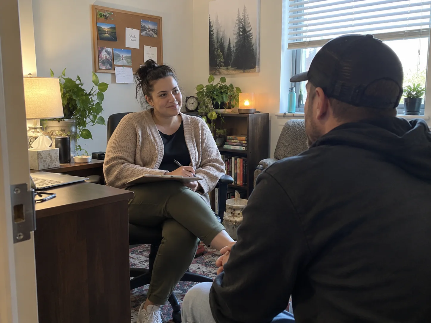 A professional meeting privately with an adult in a comfortable office